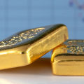 Is it better to invest in gold bars or coins?